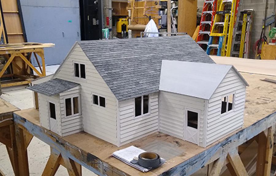 A photo of a scale model house being built in the Schwartz Center shop