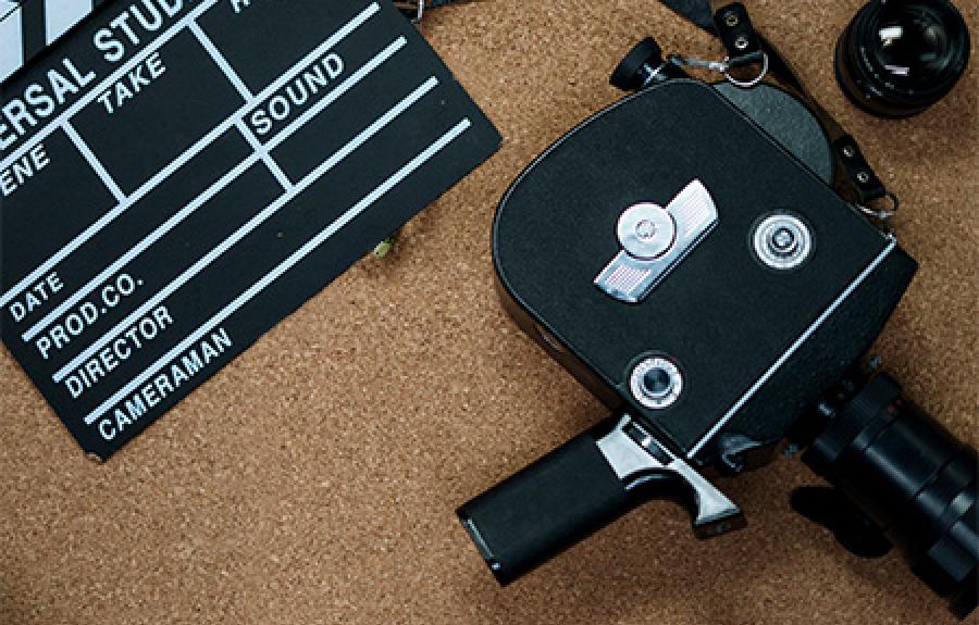 Photo of a film camera and a clapper board