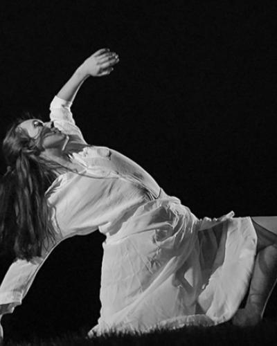 B&W image of PMA student Molly Hudson in a movement pose against a black background, as part of Yiqi (Coco) Tan’s first-prize winning dance film called Through the Eyes of a Child.