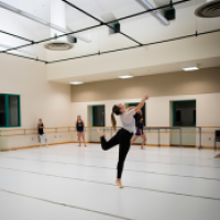 A female student practicing dance in a dance studio at the Schwartz Center, Cornell University