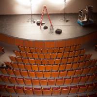 Empty theatre with lights and ladders on stage