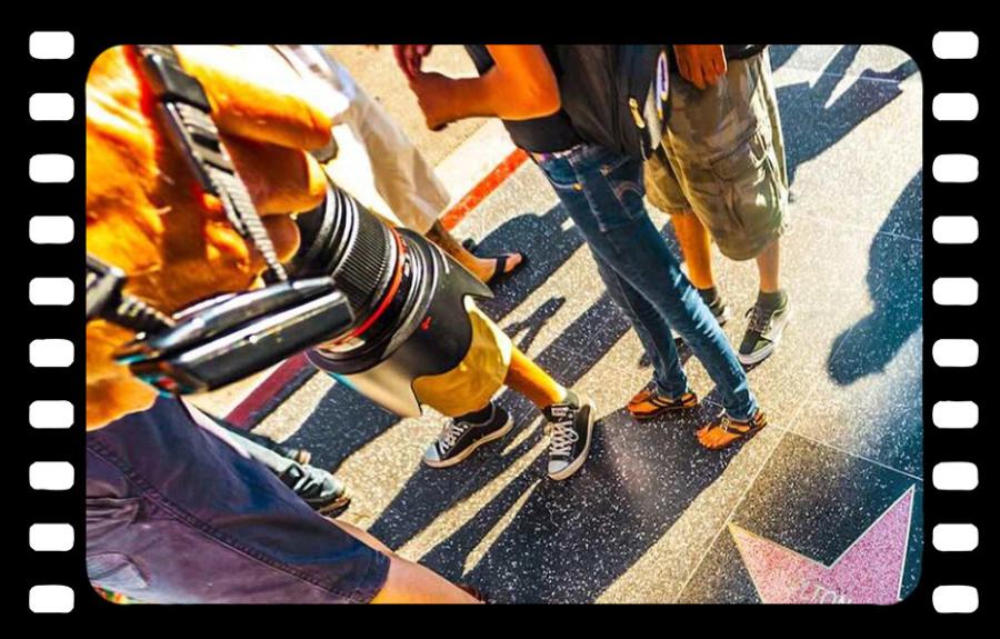 People walking around a star on the walk of fame