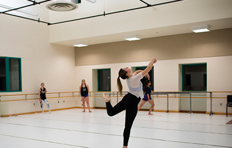 A female student practicing dance in a dance studio at the Schwartz Center, Cornell University