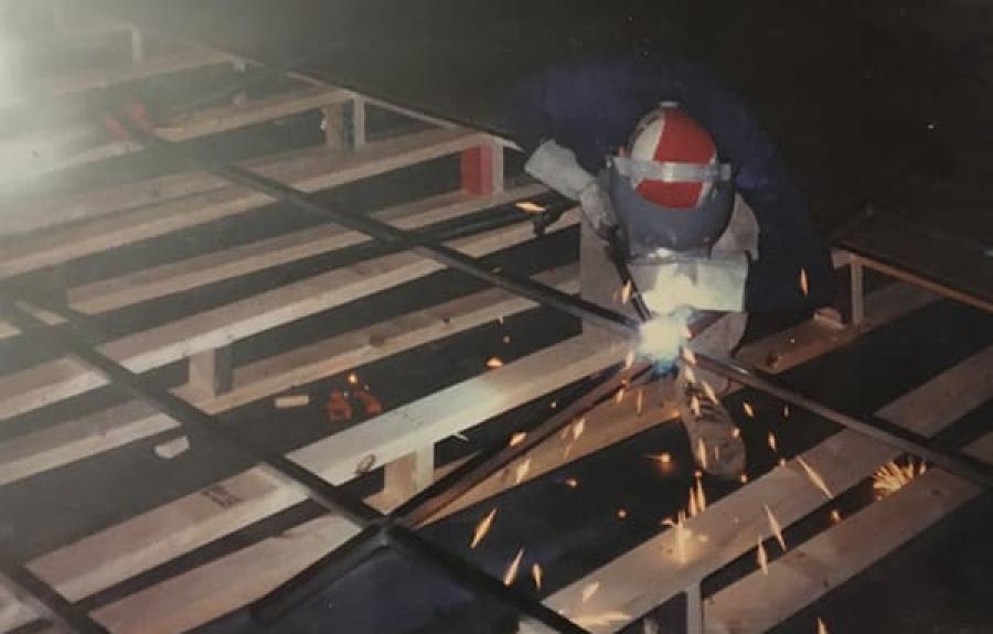 Glenn Petit welding in the scene shop in the early days of the Schwartz Center.