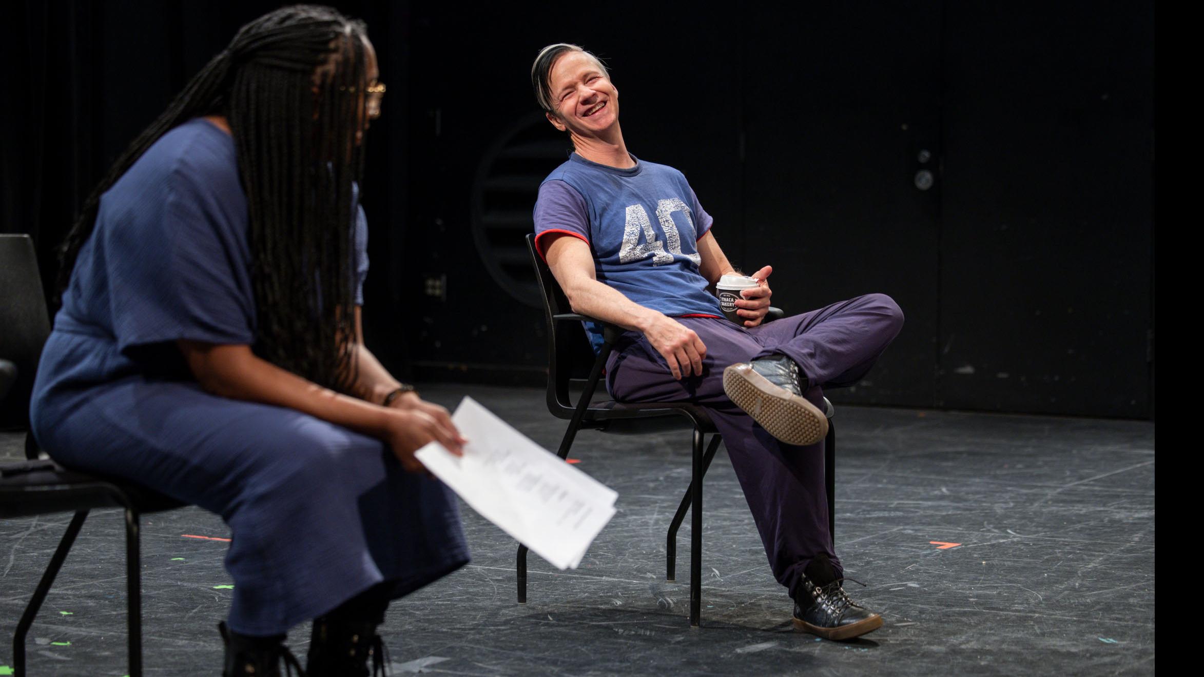 John Cameron Mitchell laughs sitting beside PMA Chair Samantha Sheppard on stage in the Black Box Theatre. Photo credit: Simon Wheeler