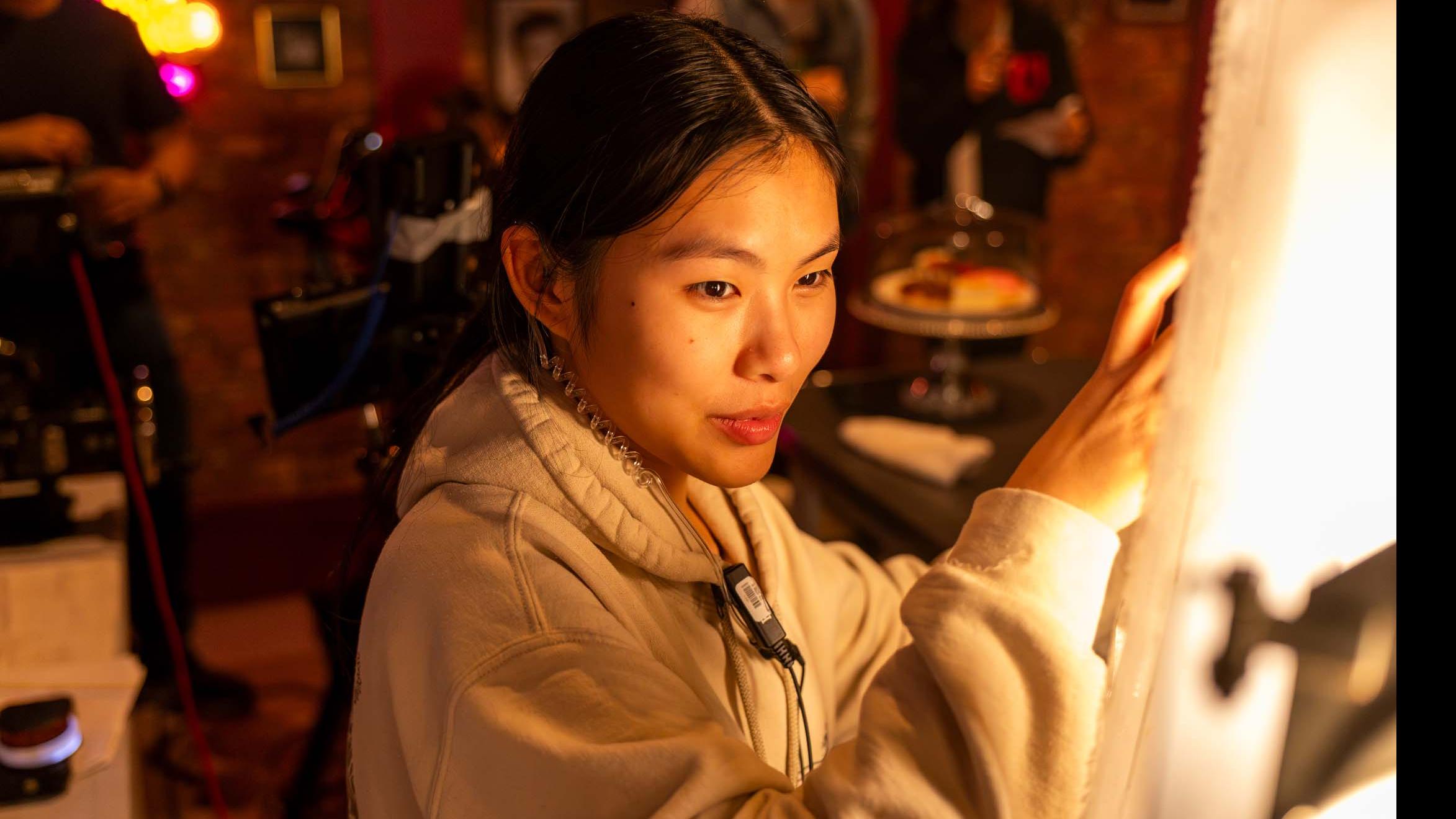 A student crew member holds a lighting panel on the set of the PMA Studios short film Milkshake Kiss. Photo credit: Simon Wheeler