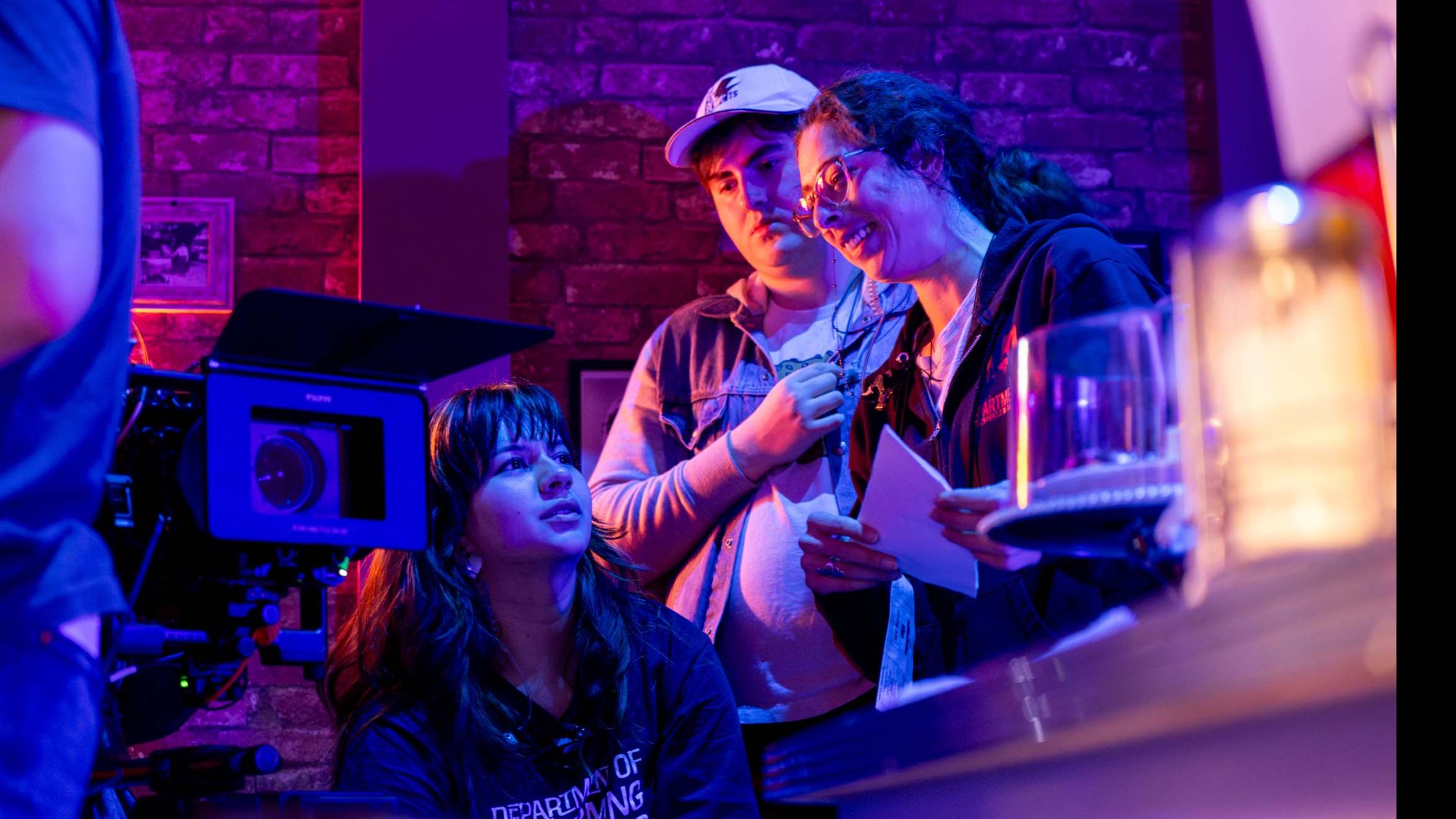 PMA staff member Alexa Alfonsi and two student crew members talk behind a camera on the set of the PMA Studios short film Milkshake Kiss. Photo credit: Simon Wheeler