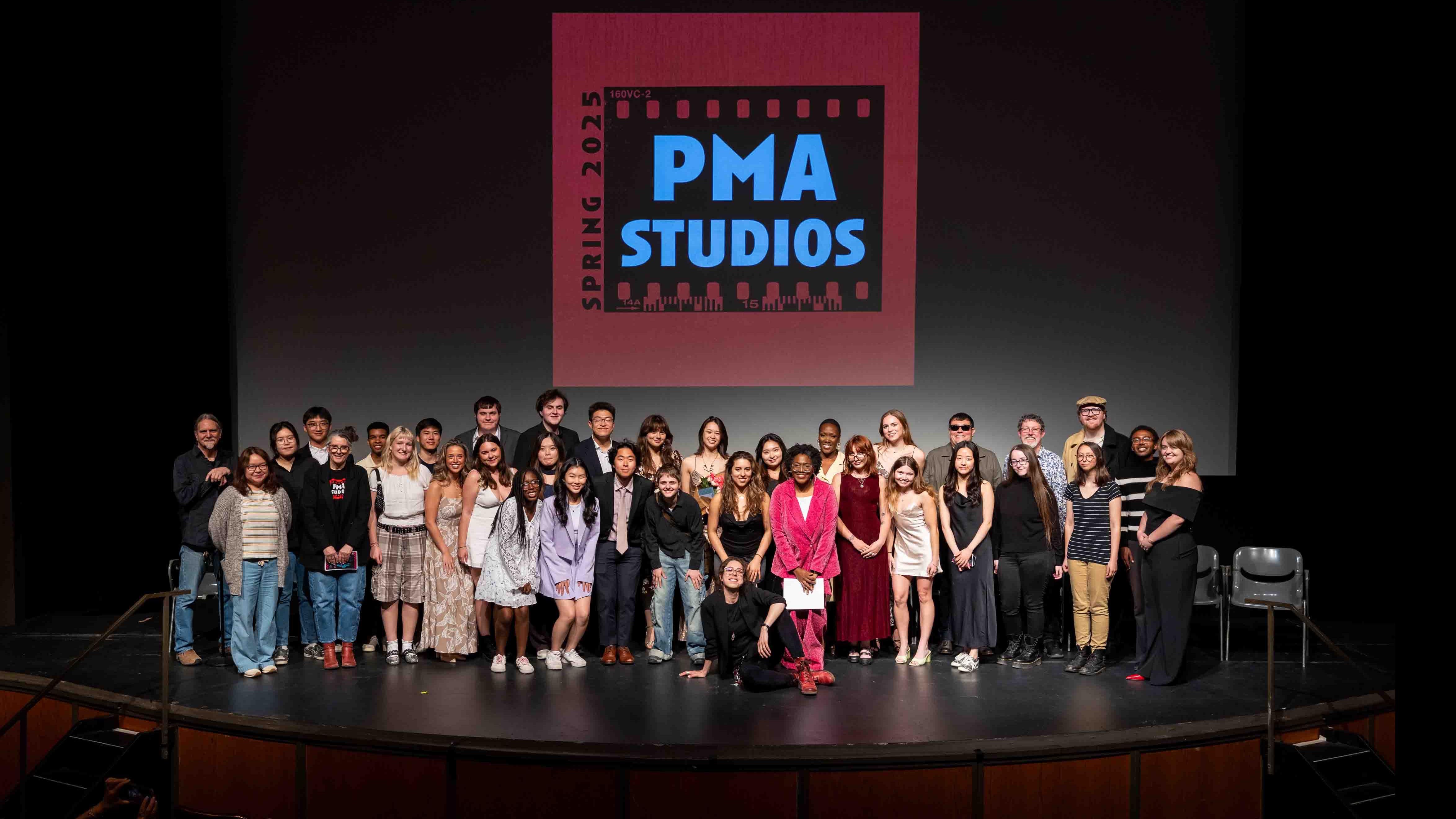 A posed photo of PMA faculty and student cast and crew of the PMA Studios short film Milkshake Kiss, on stage in the Kiplinger Theatre. Photo credit: Chris Kitchen