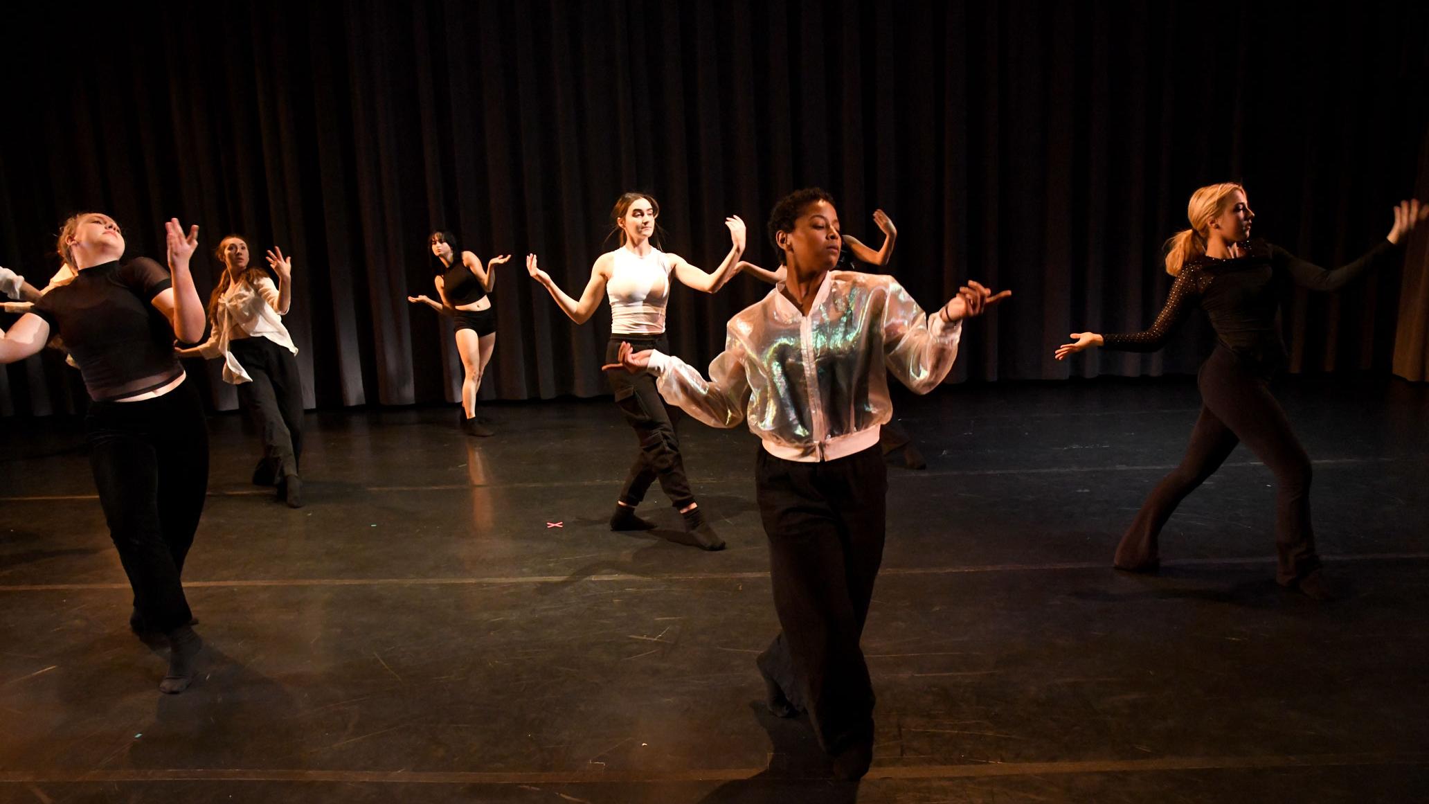 A group of PMA students dancing on stage in the Dance Theatre for Share In Share Out Fall 2024