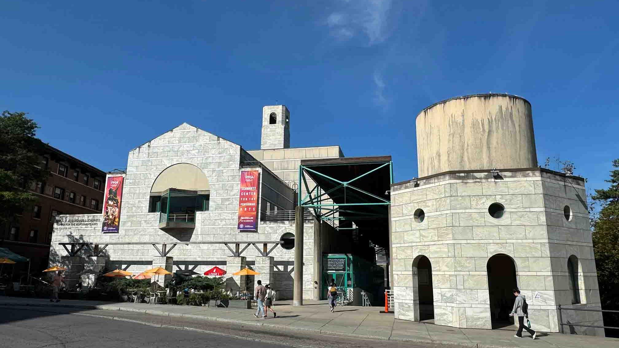 Exterior of the Schwartz Center for the Performing Arts under a blue sky, from across College Avenue.