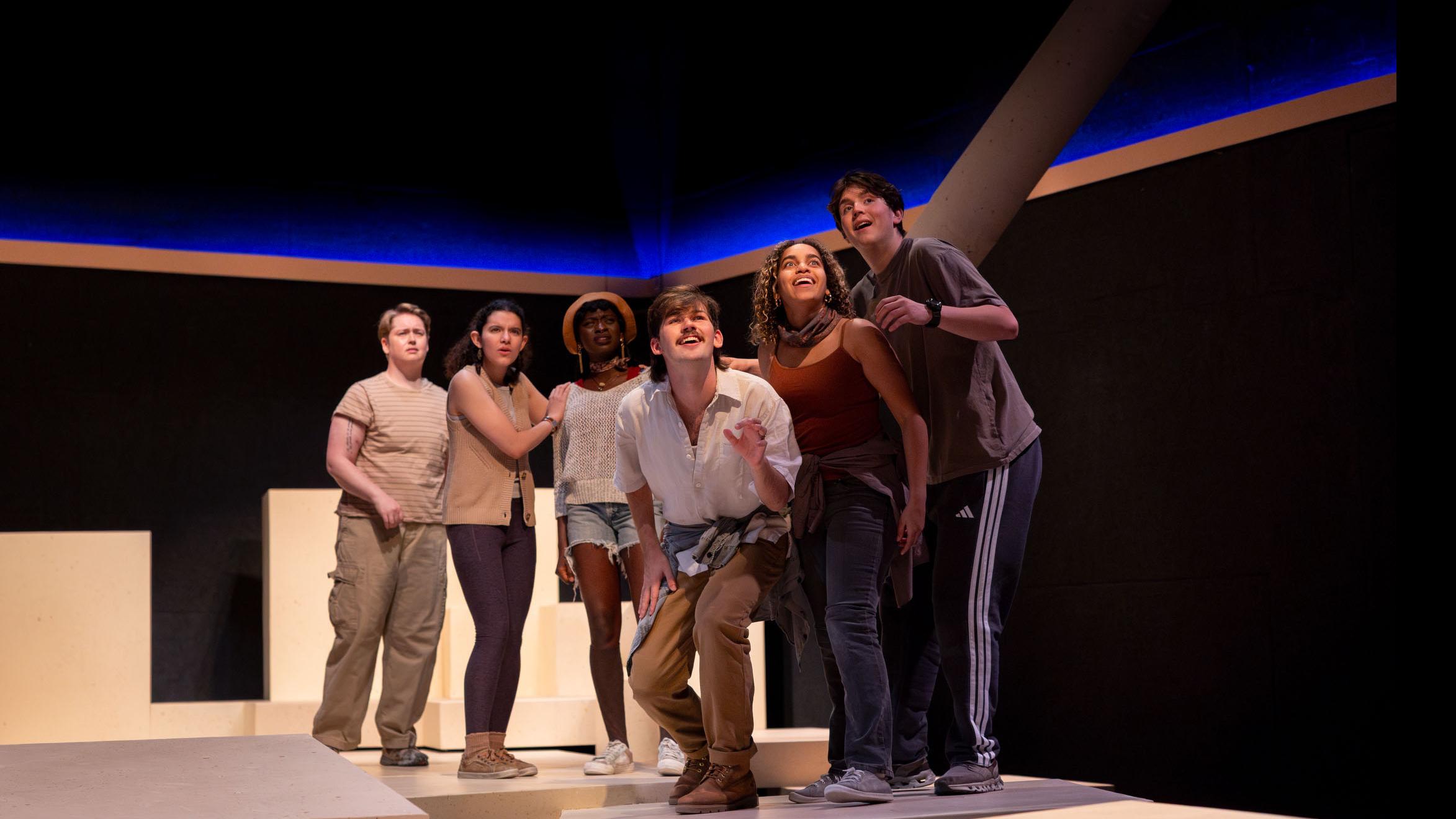 Six cast members look out during a performance of I Want a Country in the Flex Theatre, Schwartz Center for the Performing Arts.