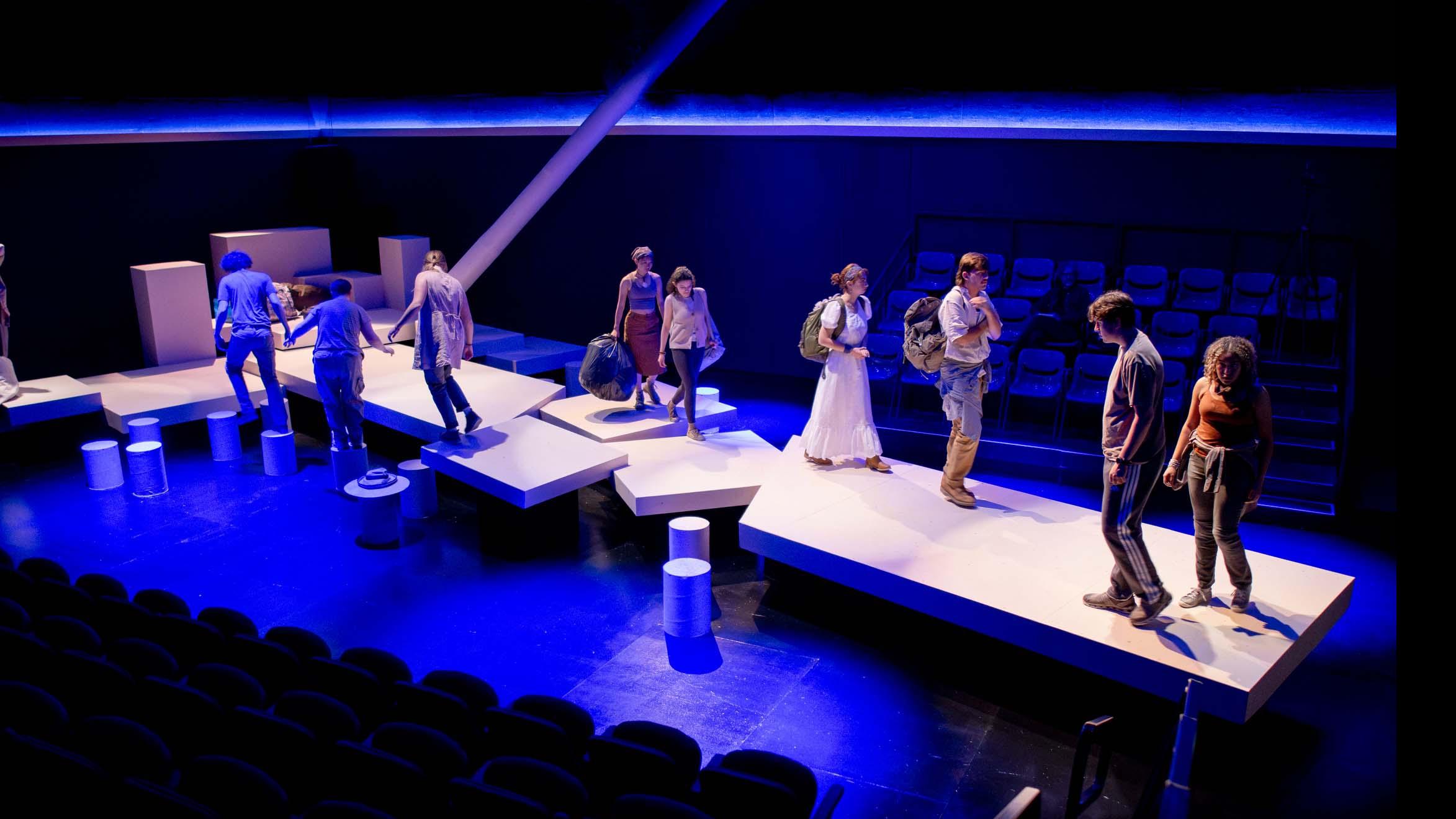 An ensemble of performers spread across the stage during a performance of I Want a Country in the Flex Theatre, Schwartz Center for the Performing Arts.