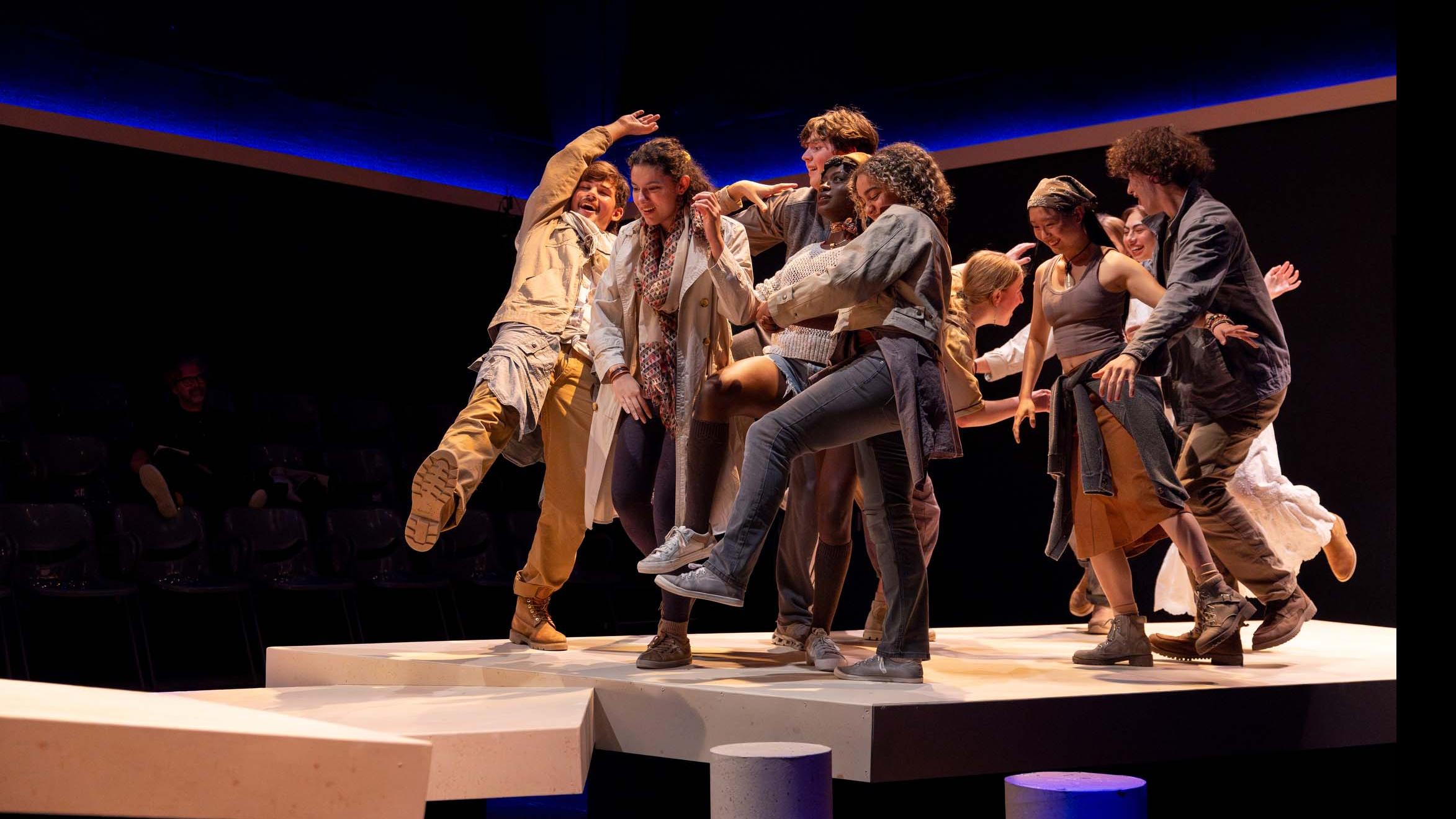 An ensemble of performers group together in movement poses during a performance of I Want a Country in the Flex Theatre, Schwartz Center for the Performing Arts.