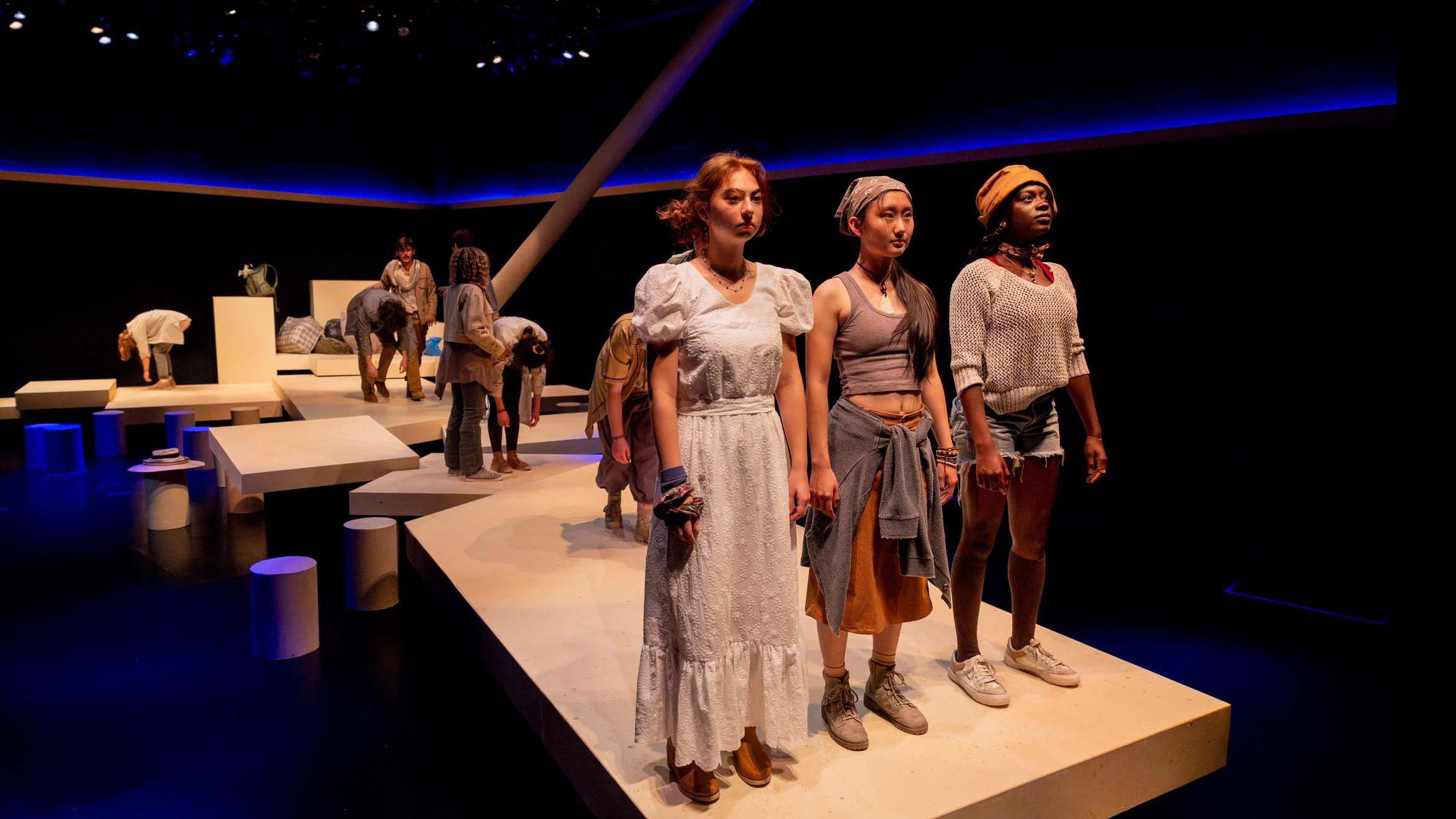 Three cast member stand in a line and look ahead during a performance of I Want a Country in the Flex Theatre, Schwartz Center for the Performing Arts.