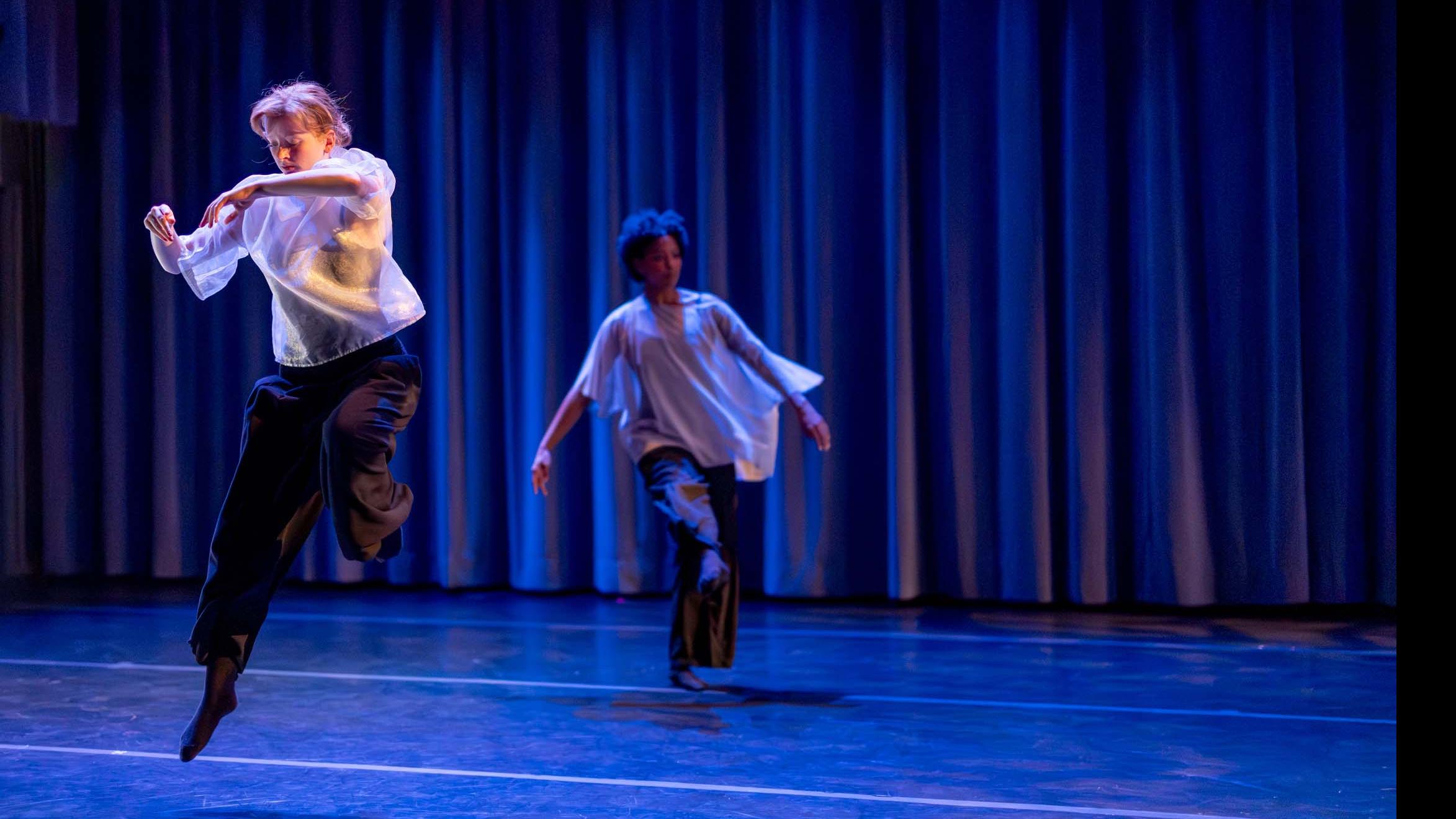 On left, Elena Caplinger, on right, Taylor Janeen Pryor in movement poses during Share In / Share Out in the Class of ’56 Dance Studio Theatre, Schwartz Center.