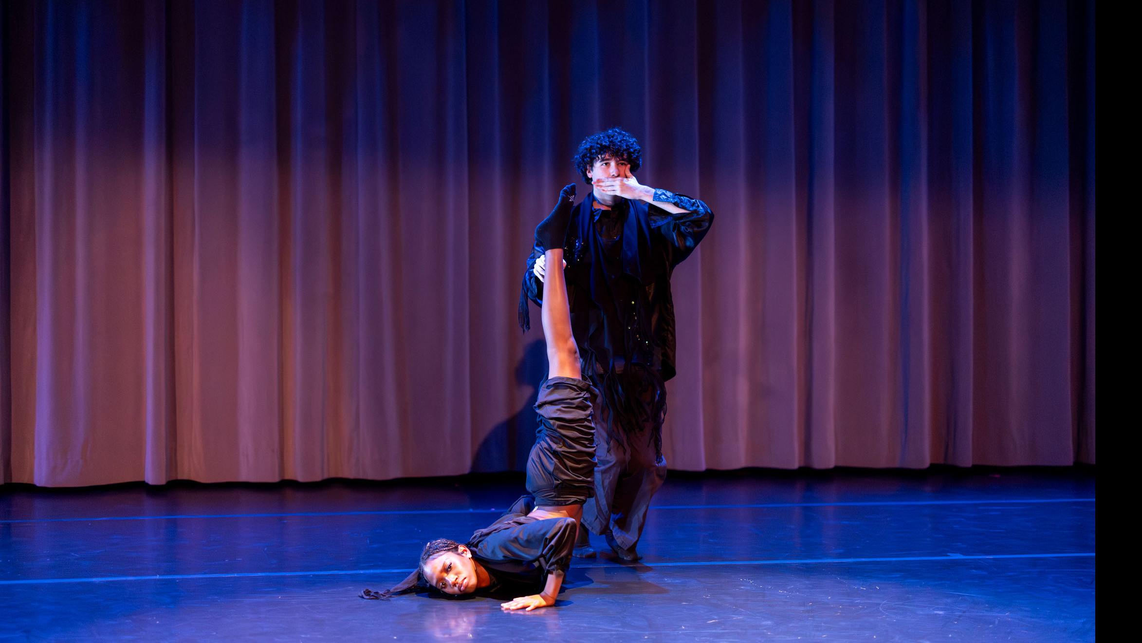 On left, Kaelyn J. Stewart, on right Nick DeMayo, in movement poses during Share In / Share Out in the Class of ’56 Dance Studio Theatre, Schwartz Center.