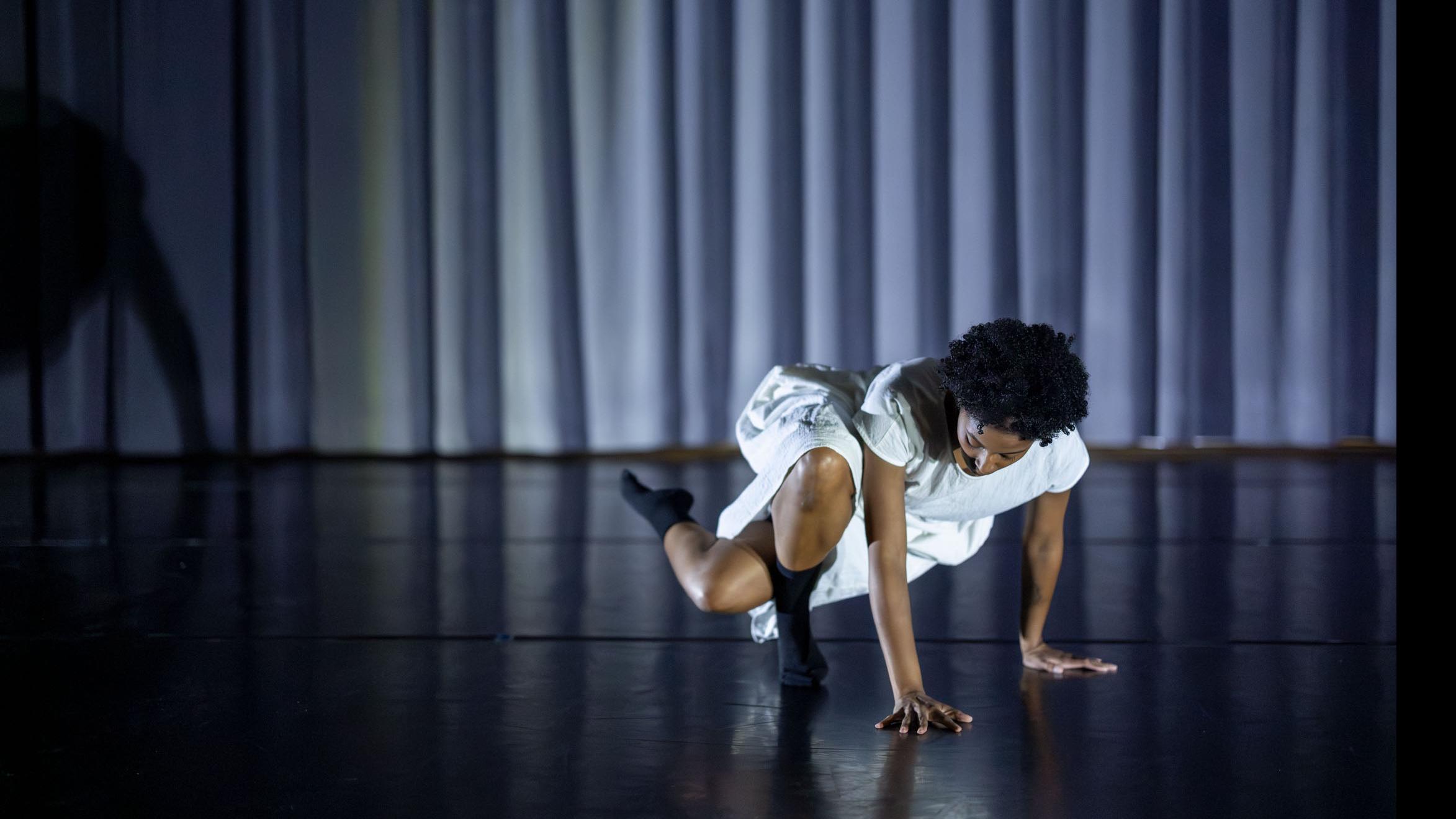 Taylor Janeen Pryor in a movement pose during Share In / Share Out in the Class of ’56 Dance Studio Theatre, Schwartz Center.
