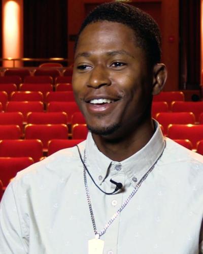 Photo of Trence Gilllem '22 sitting in the Kiplinger Theatre