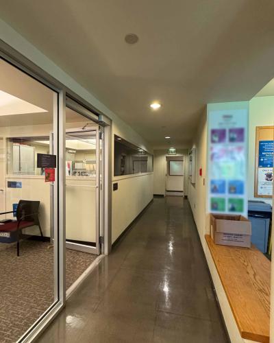Hallway on the second floor of the Schwartz Center for the Performing Arts leading to the lounge and two single-use all-gender bathrooms.