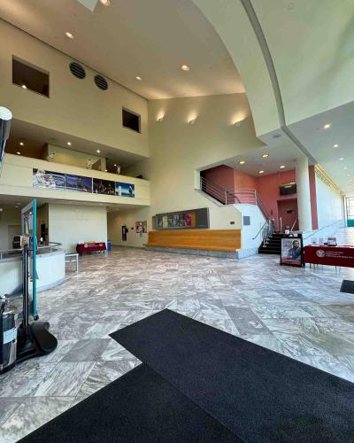 Schwartz Center for the Performing Arts main floor lobby, with the elevator on the left and the entrances to the Kiplinger Theatre on the right.