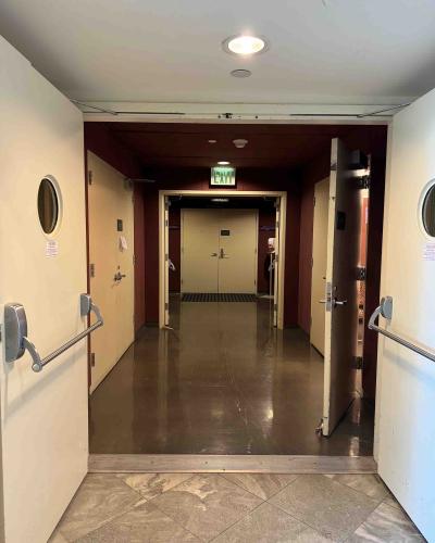 Three pairs of open double doors on the main floor of the Schwartz Center for the Performing Arts, leading to the Class of ’56 Flexible Theatre.
