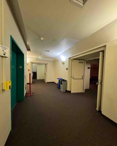 Elevator in the basement of the Schwartz Center for the Performing Arts, with stairs leading up to the main floor in the background, and a doorway leading into the Film Forum on the right.