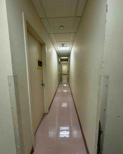 Hallway on the main floor of the Schwartz Center for the Performing Arts lobby, with a single-use all-gender bathroom in the background.