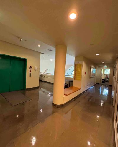 Elevator on the second floor of the Schwartz Center for the Performing Arts, with a hallway leading around the corner to Chair's Suite Room 220 on the right.