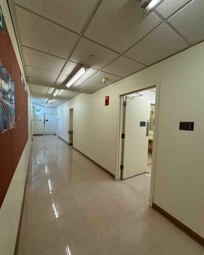 Multi-person women’s and men’s bathrooms and locker rooms on the third floor of the Schwartz Center for the Performing Arts, with a doorway leading to emergency exit stairs in the background.