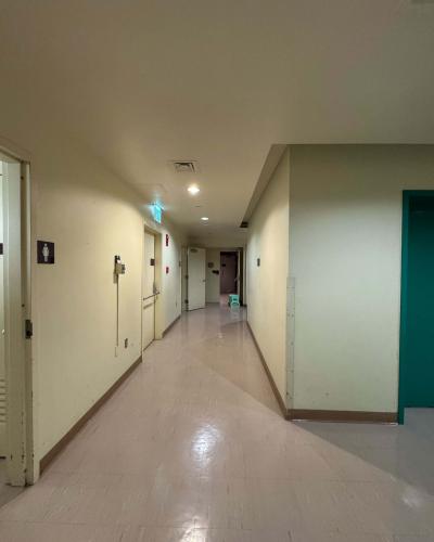 Multi-person women’s and men’s bathrooms in the sub-basement of the Schwartz Center for the Performing Arts, with a doorway leading to the Class of ’56 Dance Studio Theatre in the background, and an elevator on the right.