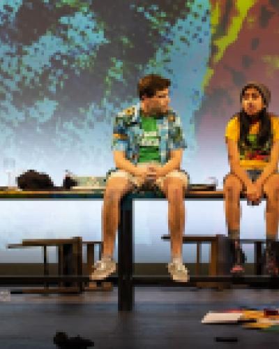 Two teenage actors in The Next Storm sit on the edge of a table. Photo by Youngsun Palmer.