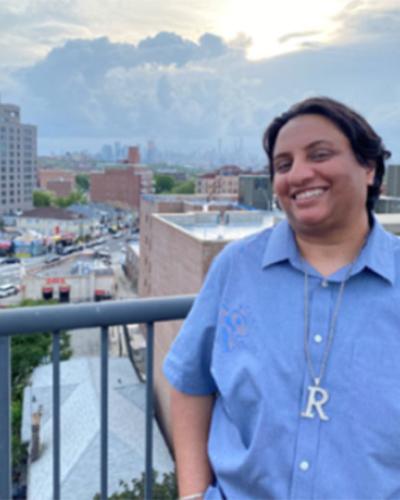 Rekha Malhotra with city skyline in background