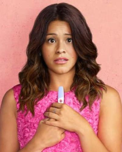 Latina actress Gina Rodriguez holding a pregnancy test