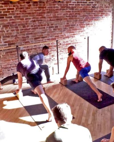 Yoga practioners in a YoGay class