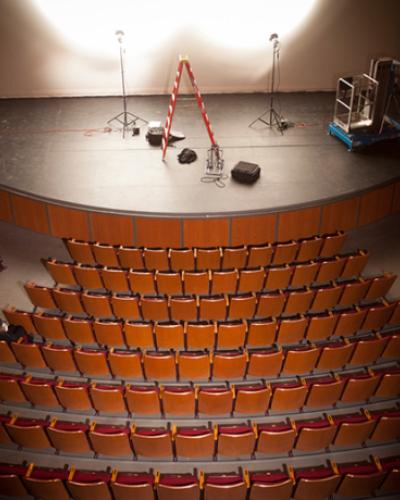 Empty theatre with lights and ladders on stage
